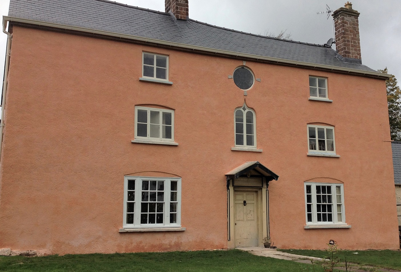 A property in Clearwell that was Roughcast and then lime washed in a traditional pink to celebrate the red ochre pigment mined in Clearwell Caves.