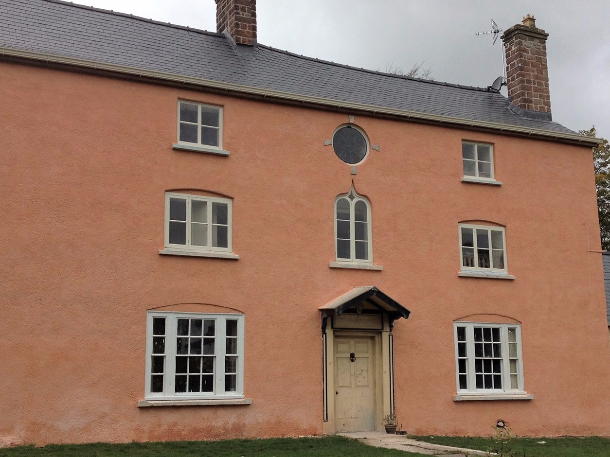 A property in Clearwell that was Roughcast and then lime washed in a traditional pink to celebrate the red ochre pigment mined in Clearwell Caves.